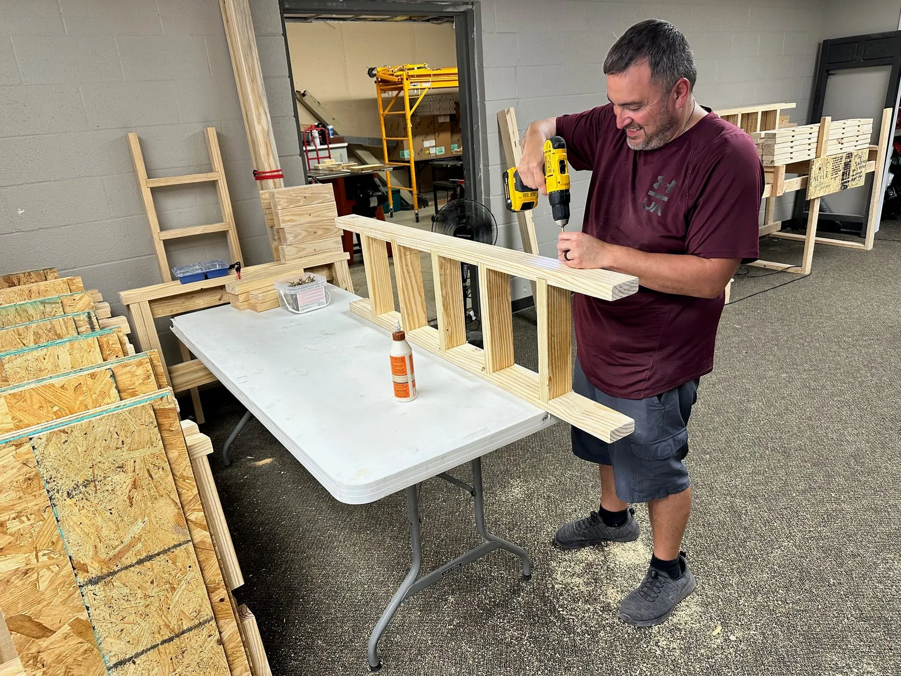 A Highland volunteer building a wooden bed through Beds4Kids