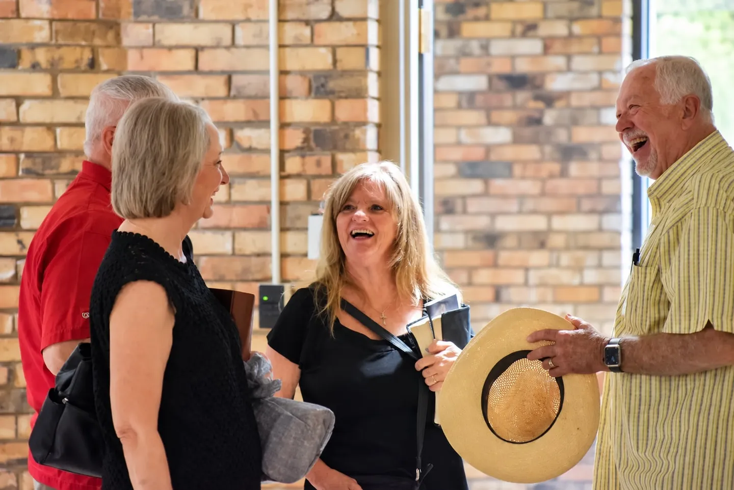 Highland members smiling and talking together inside the church