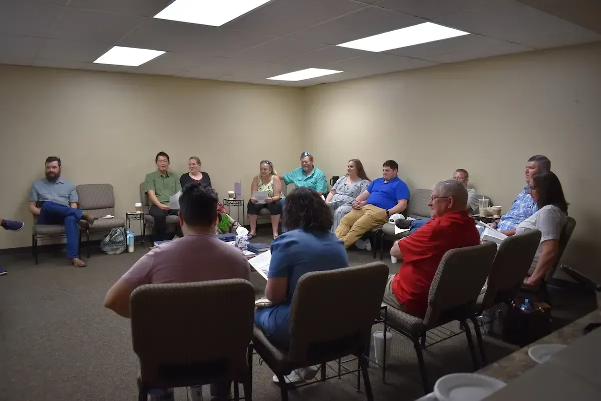 Adults gathered in conversation during a Life Group at Highland Baptist Church