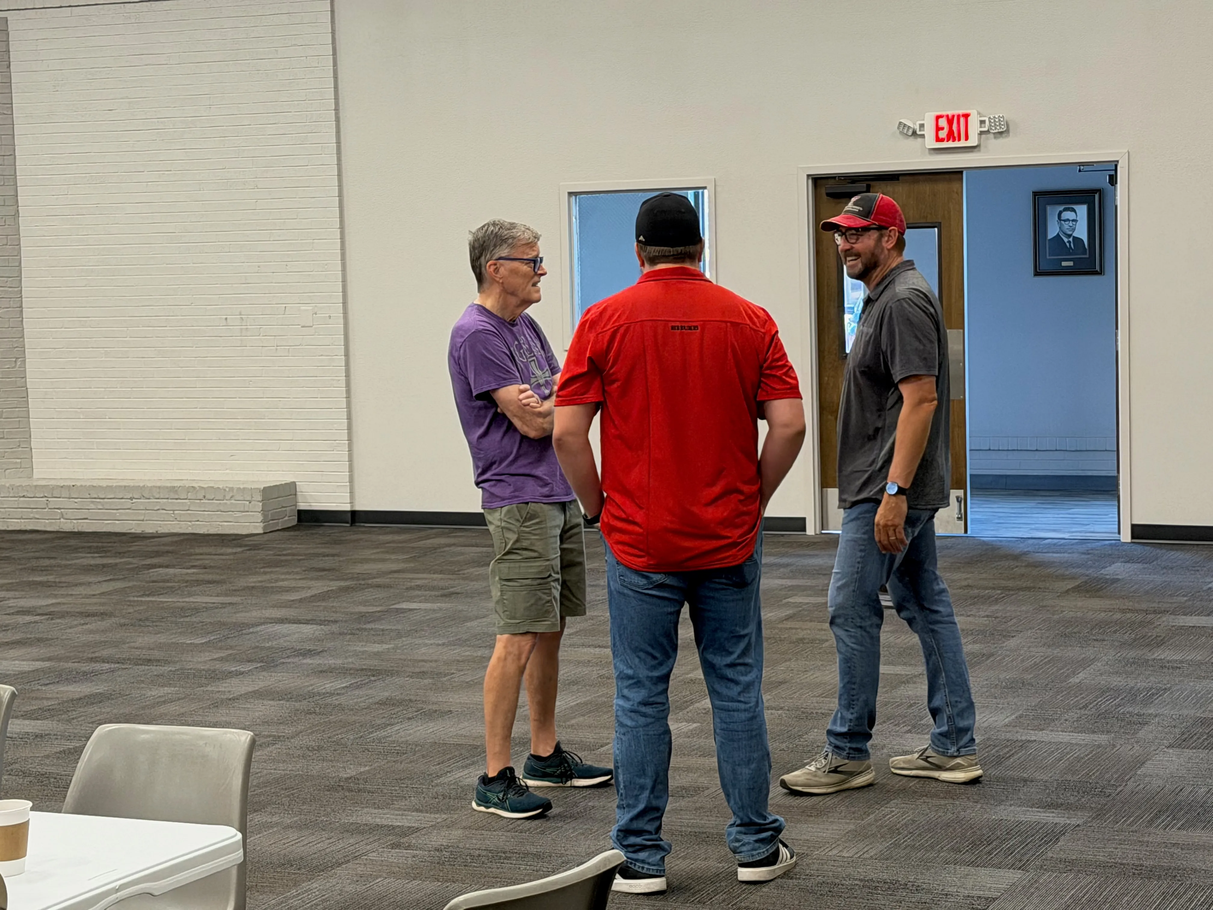 Three men enjoying conversation together